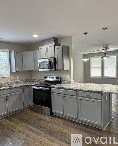 A kitchen with a stove top oven and microwave.