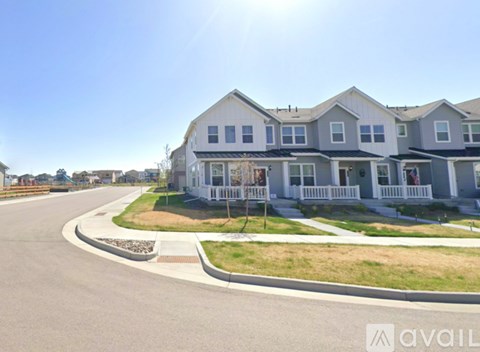 A row of houses with a clear blue sky above them.