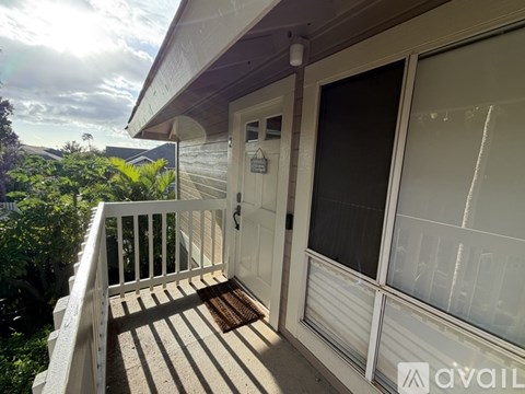 A balcony with a door and a window.