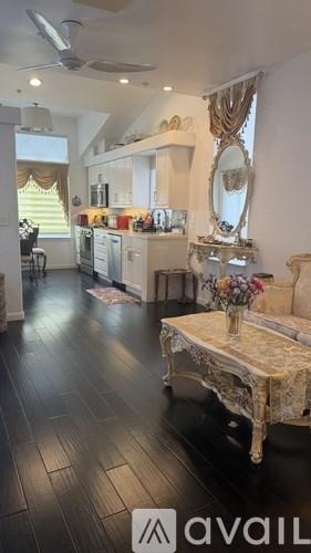A living room with a coffee table and a mirror on the wall.