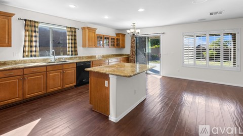 A kitchen with wooden cabinets and a central island.