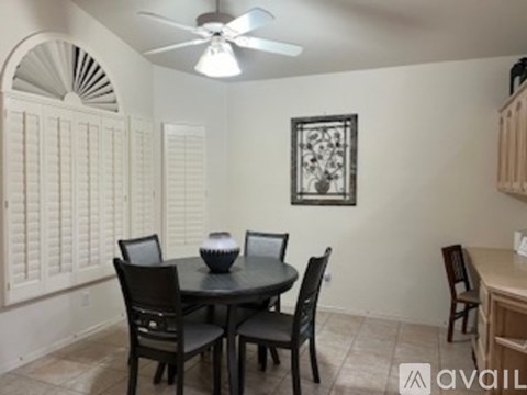A dining room with a table set for four.