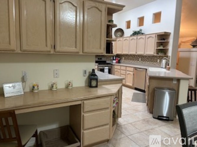 A kitchen with a desk and drawers underneath it.
