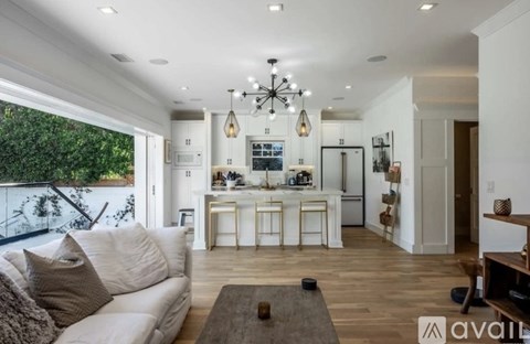 A modern living room with a white couch and a wooden coffee table.