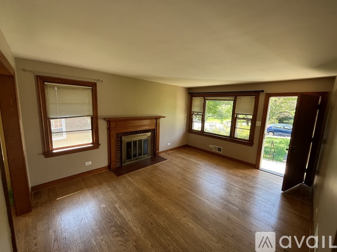A room with a fireplace and wooden floors.