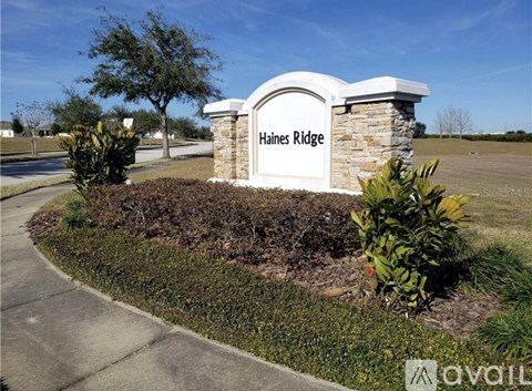A sign that says "Haines Ridge" is in front of a grassy area.
