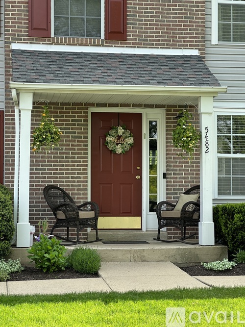 A house with a brown door and a wreath on it.