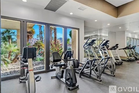 A gym with treadmills, exercise bikes and elliptical machines.