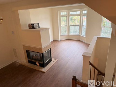 A living room with a fireplace and a box on top of it.