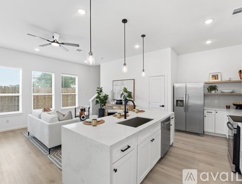 A modern kitchen with white cabinets and a large island.