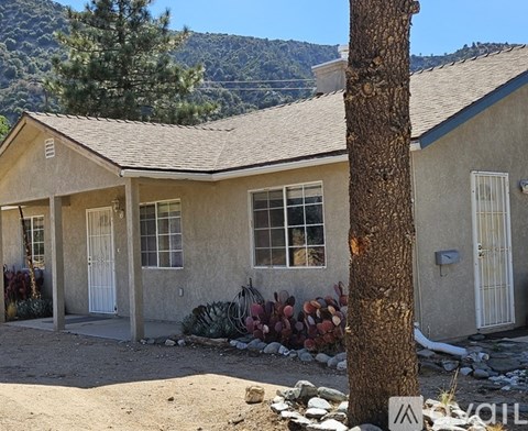 A house with a tree in front of it.