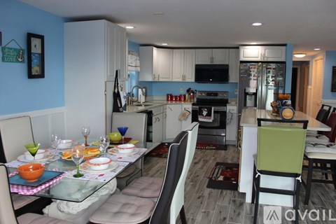A kitchen with a table set for a meal.