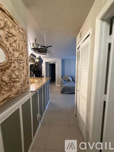 A kitchen with a counter and a fan.
