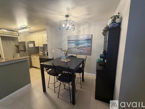 A dining area with a table and chairs.
