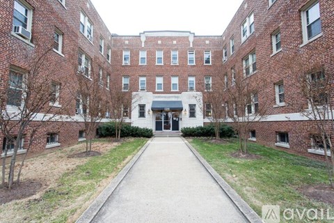 A brick building with a white door and windows.