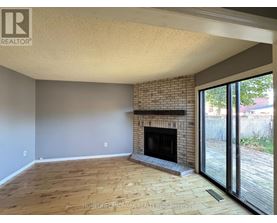 A living room with a fireplace and sliding glass doors.