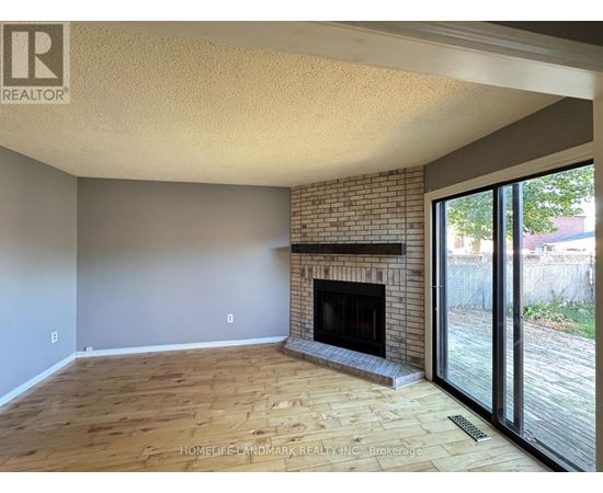 A living room with a fireplace and sliding glass doors.