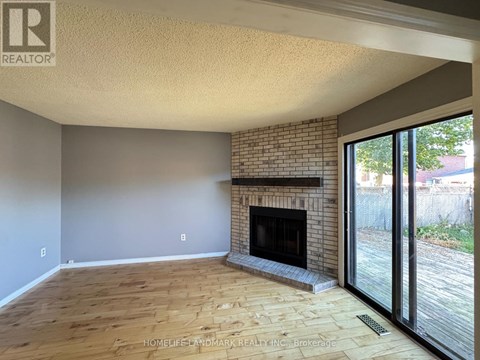 A living room with a fireplace and sliding glass doors.