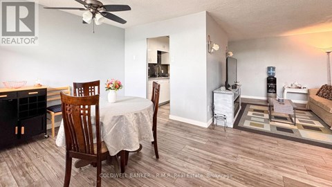 A dining room with a white table and chairs is shown.