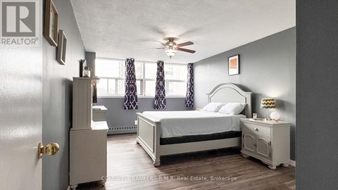 A bedroom with a bed, nightstand, and a dresser.