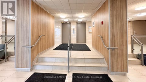 A hallway with a sign that says R. Real Estate Brokerage.