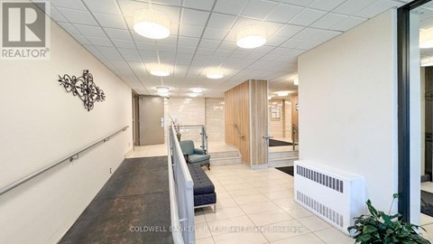 A hallway with a bench and a wall with a sign that says REALTOR.