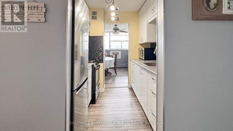 A kitchen with a fridge and a sign that says "Welcome Home".