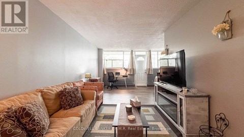 A living room with a couch, a television, and a coffee table.