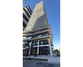 A modern building with a curved facade and a tall, pointed section.