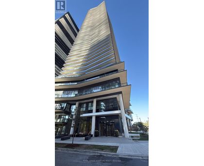 A modern building with a curved facade and a tall, pointed section.