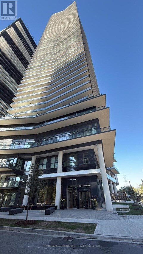 A modern building with a curved facade and a tall, pointed section.