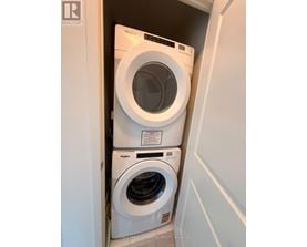 A white washing machine and dryer in a small laundry room.