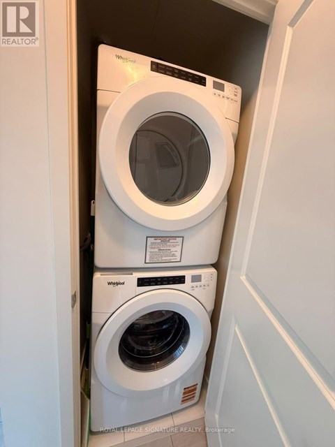 A white washing machine and dryer in a small laundry room.