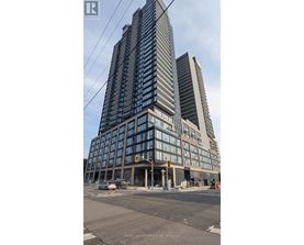 A tall building with many windows is under construction.