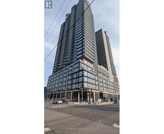 A tall building with many windows is under construction.