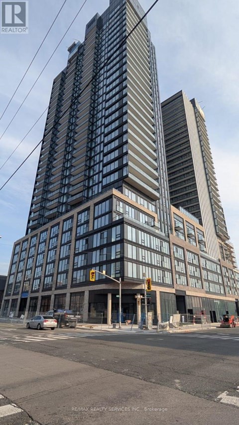 A tall building with many windows is under construction.