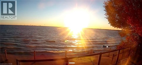 A sunset over the ocean with the sun reflecting on the water.