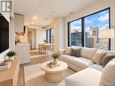 A modern living room with a large window overlooking the city.