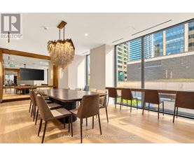 A conference room with a long table and chairs.