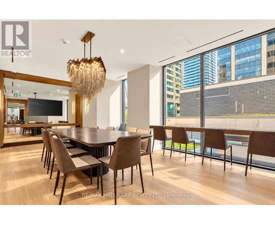 A conference room with a long table and chairs.