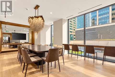 A conference room with a long table and chairs.