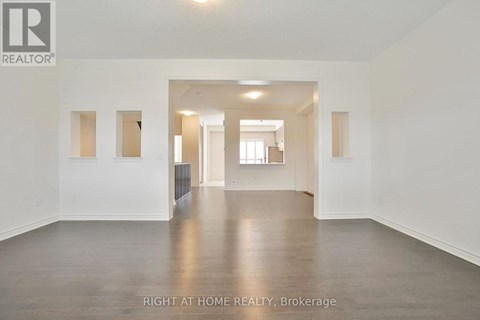 A spacious room with a radiator and a door leading to another room.