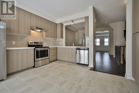 A modern kitchen with wooden cabinets and a tile floor.