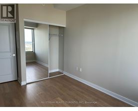 A room with a sliding door leading to a balcony.