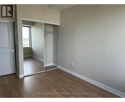 A room with a sliding door leading to a balcony.