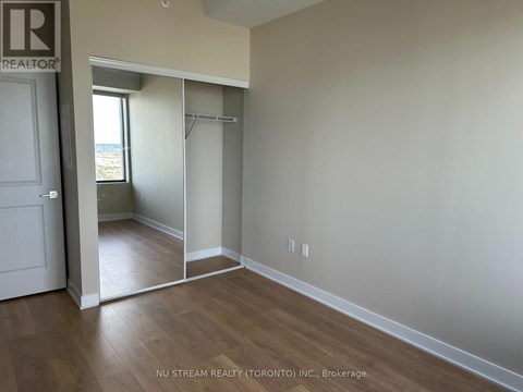 A room with a sliding door leading to a balcony.