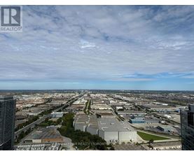 A cityscape with a clear sky and a few clouds.