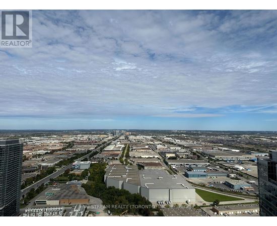 A cityscape with a clear sky and a few clouds.