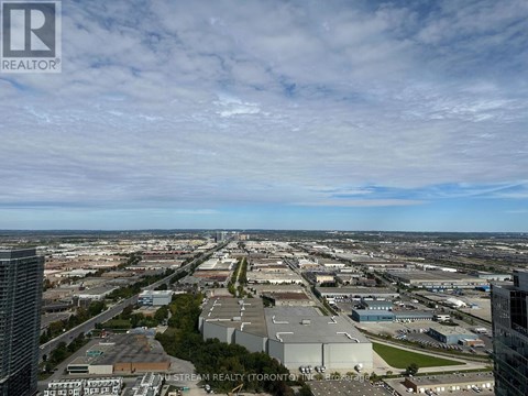 A cityscape with a clear sky and a few clouds.