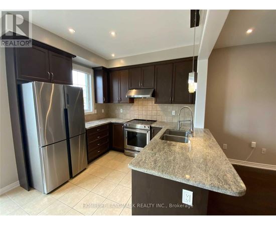 A kitchen with granite countertops and stainless steel appliances.
